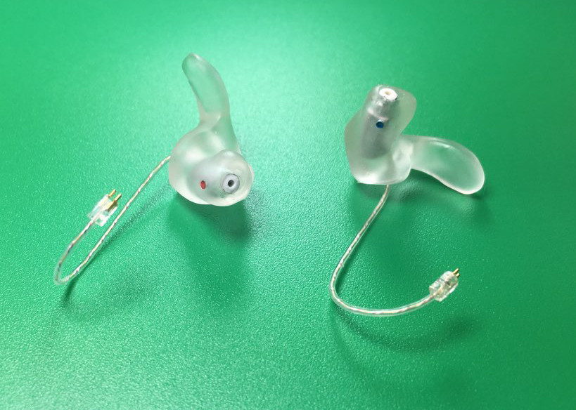 Clear earmold pair; right marked red, left marked blue